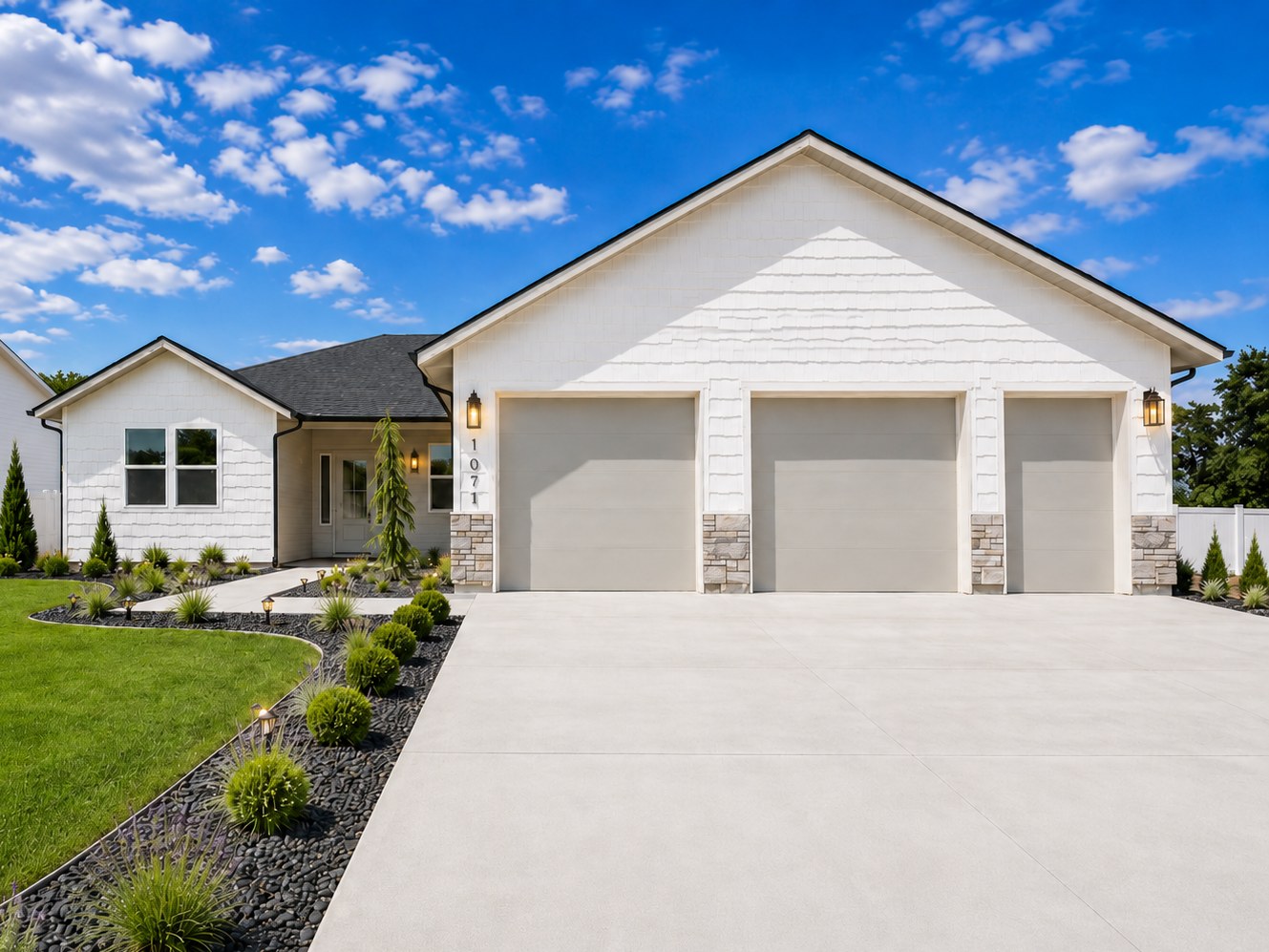 A finished single-level New Beginning Homes house with a three-car garage and landscaped front yard