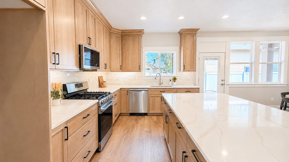 Kitchen in a finished New Beginning Homes house, with quartz counters and a large island